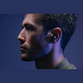 Wizard Pro wireless earbuds with charging case on textured black background