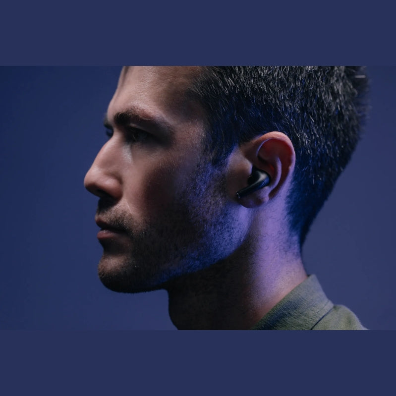 Wizard Pro wireless earbuds with charging case on textured black background